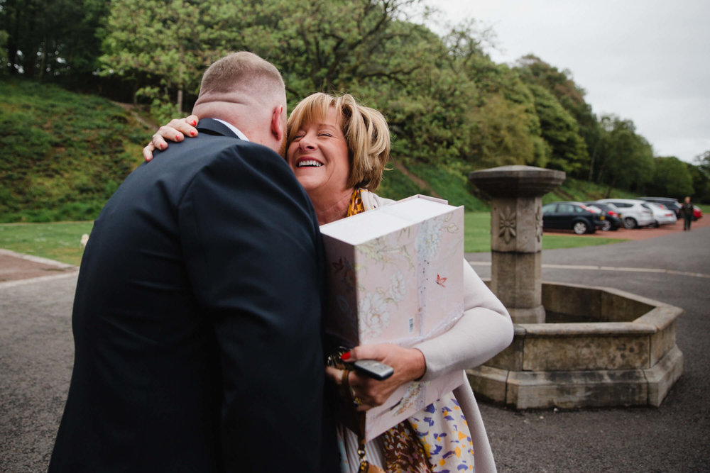 wedding guest greeting groom before ceremony