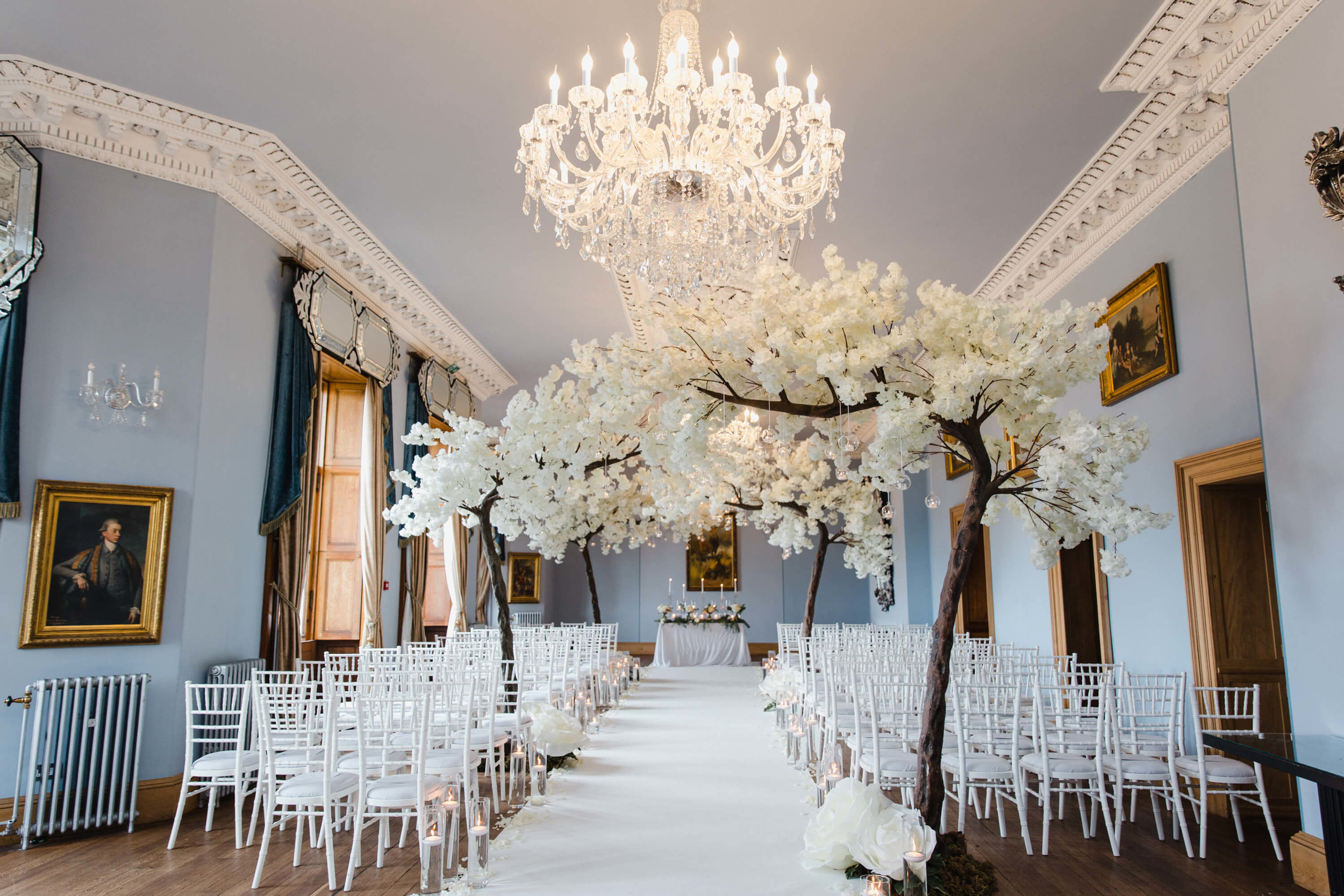 wedding ceremony aisle dressed with blossom trees by kelly louise floral artistry