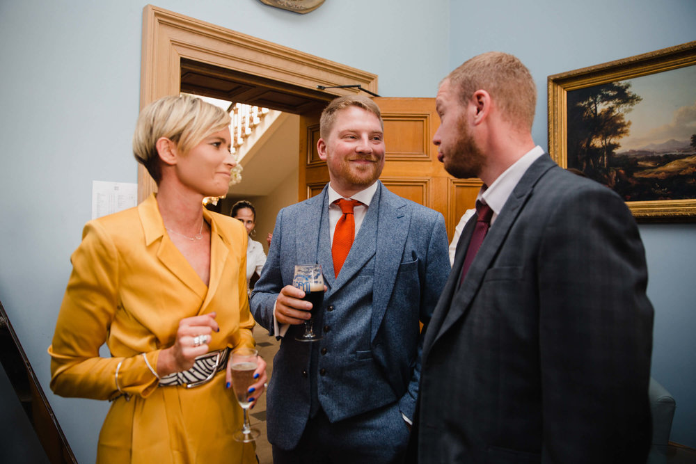 wedding guests enjoying drinks together at haigh hall