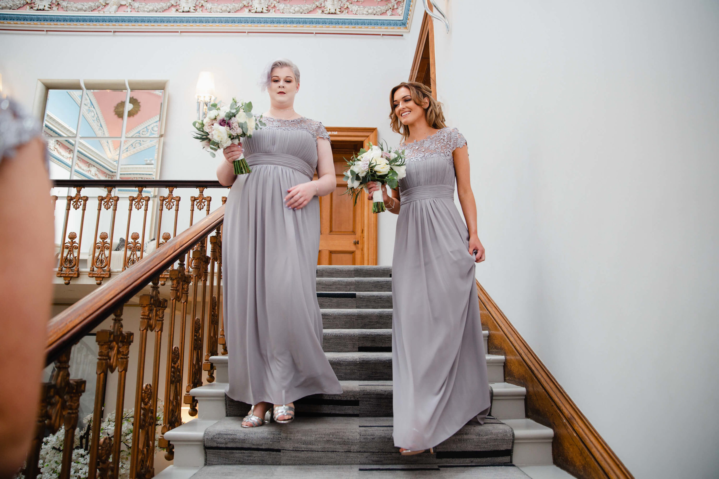maid of honor carrying bouquet of bridal flowers to ceremony