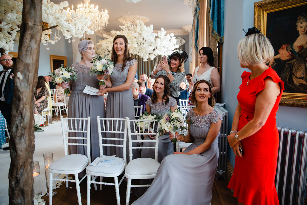 bridesmaids smiling and laughing to camera at haigh hall