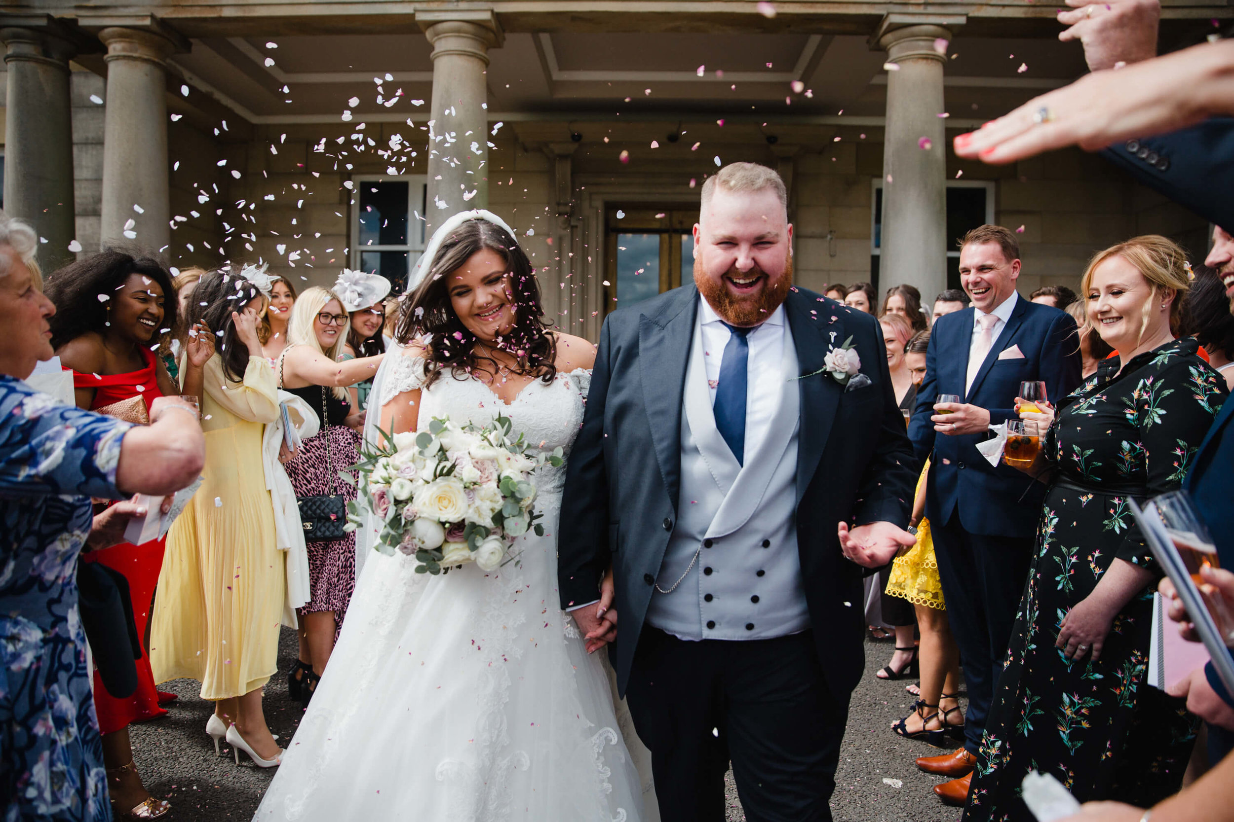 newly wedded couple enjoying confetti from guests after getting married