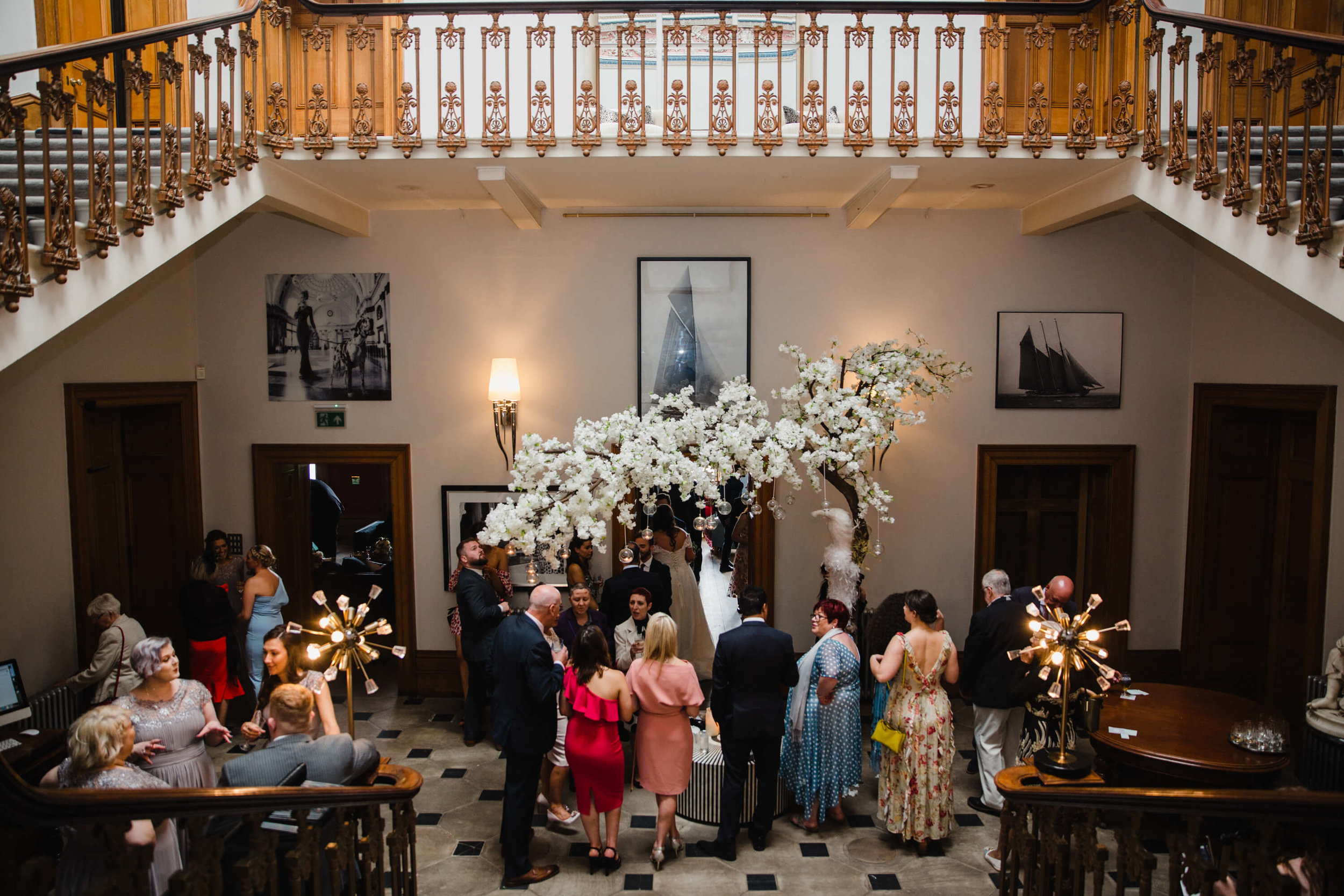 wide angle drinks reception photograph under staircase at haigh hall