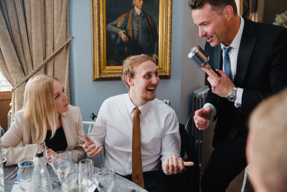 wedding guest singing into microphone during entertainment