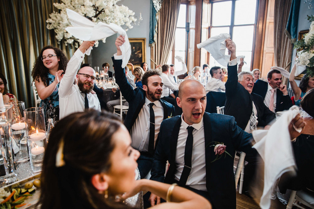 groomsmen waving handkerchiefs while singing