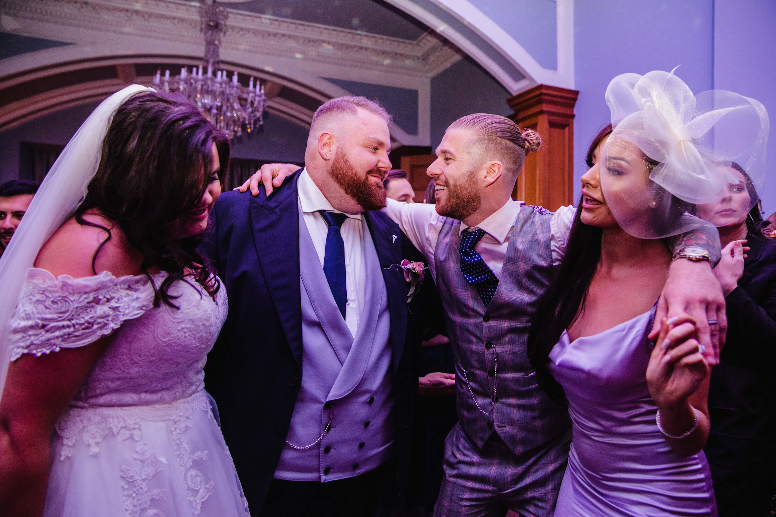 newlyweds exchange hug and congratulations on dancefloor at haigh hall