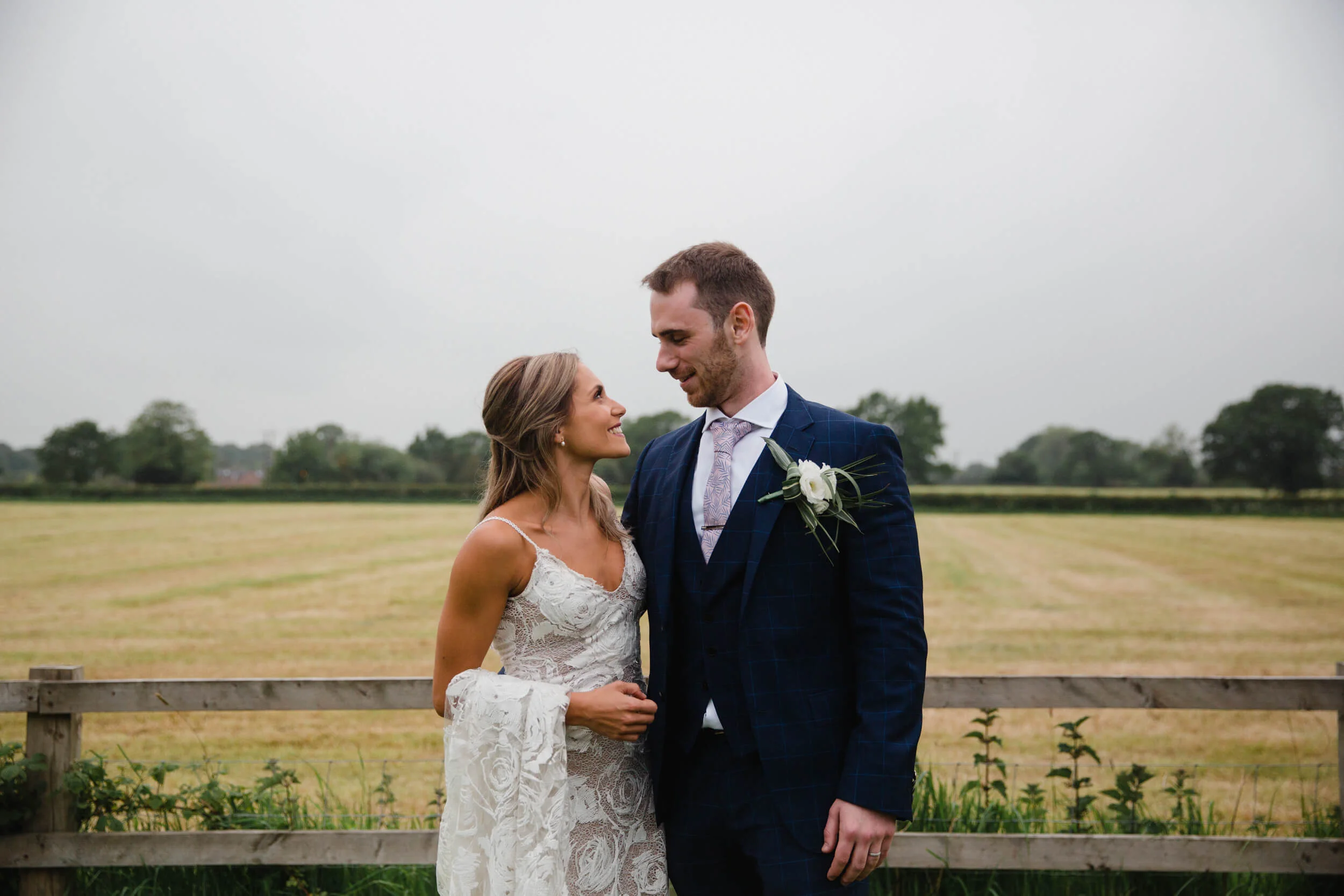 newlyweds pose together in front of The Colony HQ Wedding Venue