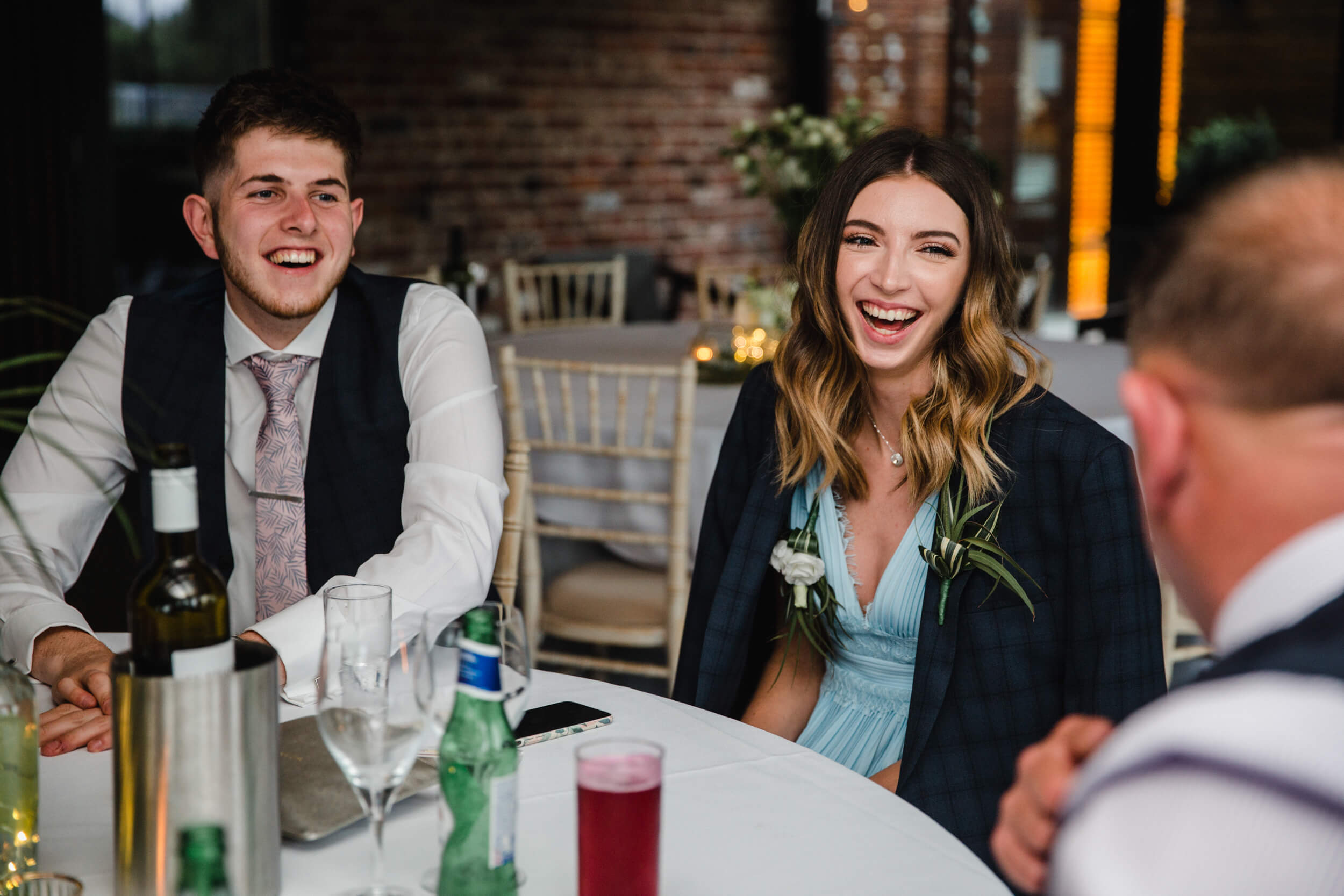 wedding guests laughing at base jokes with family