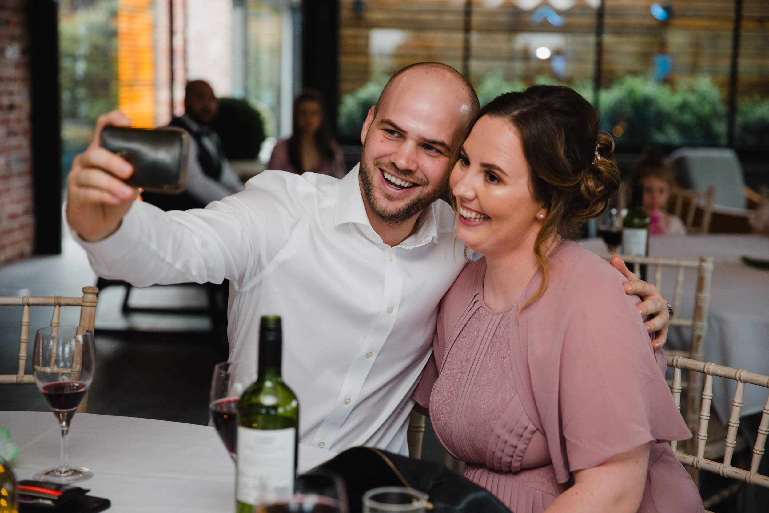 wedding couple taking selfie photograph with camera phone