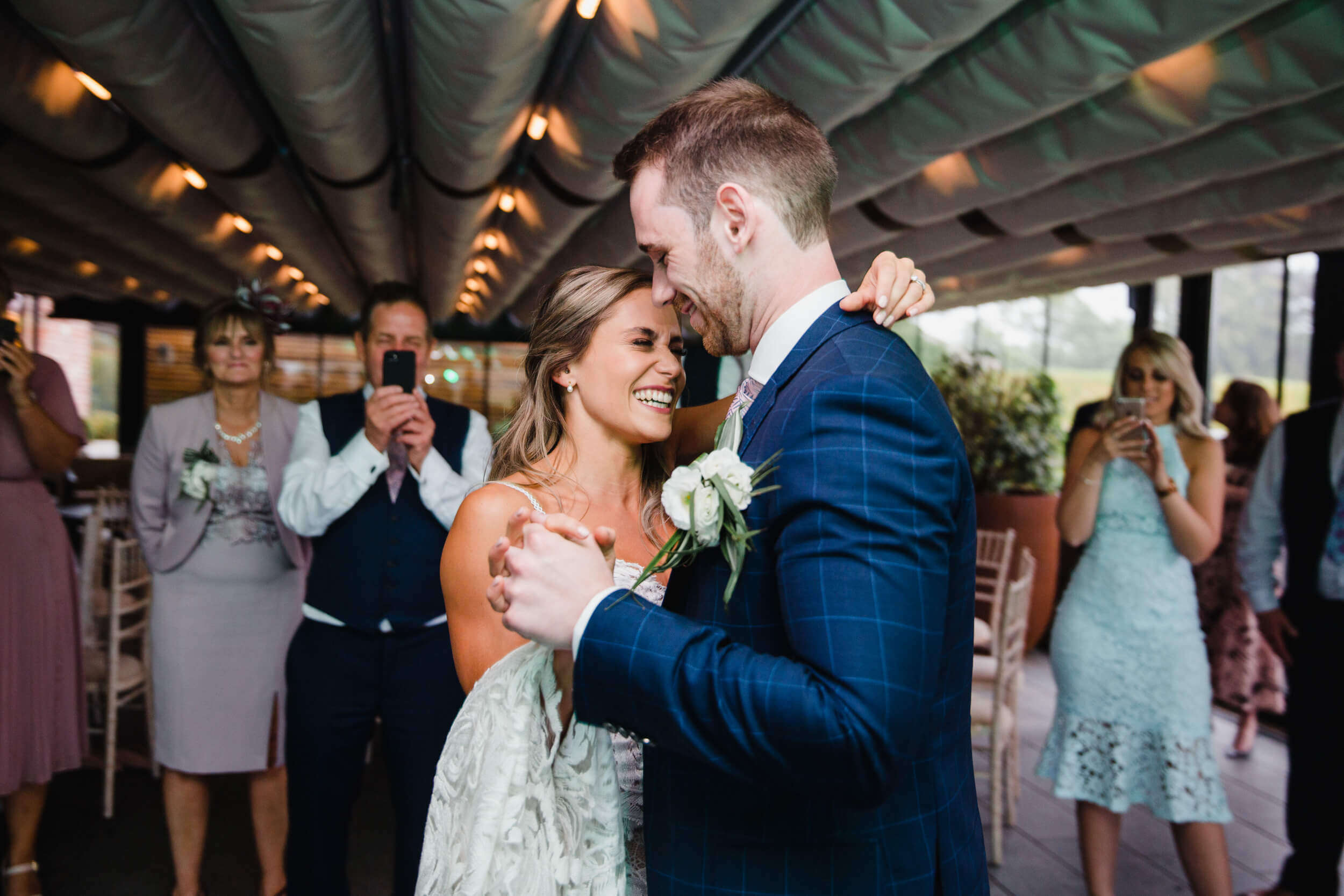 bride laughing and sharing a joke with groom on the dancefloor of headquarters