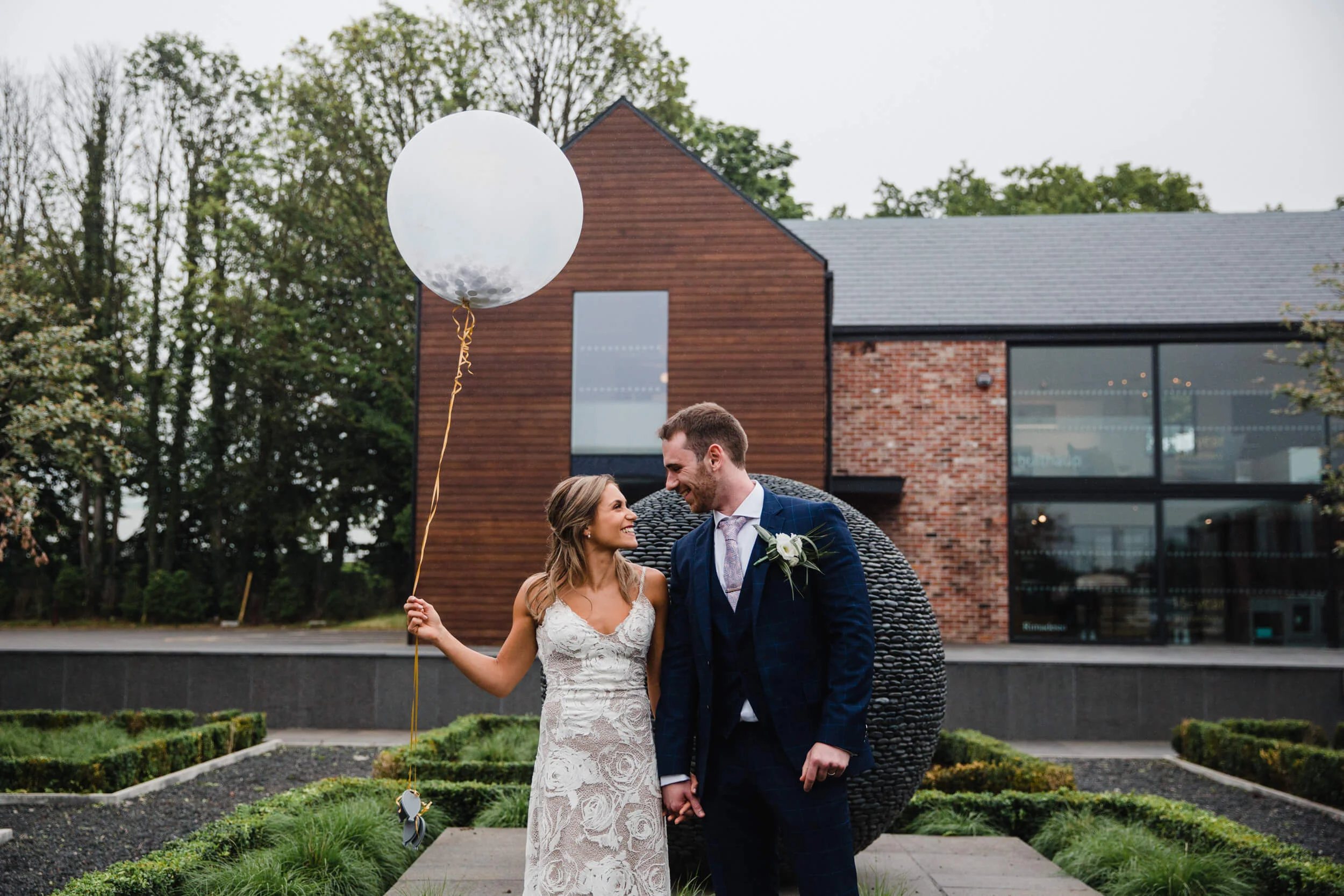 close up landscape portrait of bride and groom settle together in gardens of colony HQ