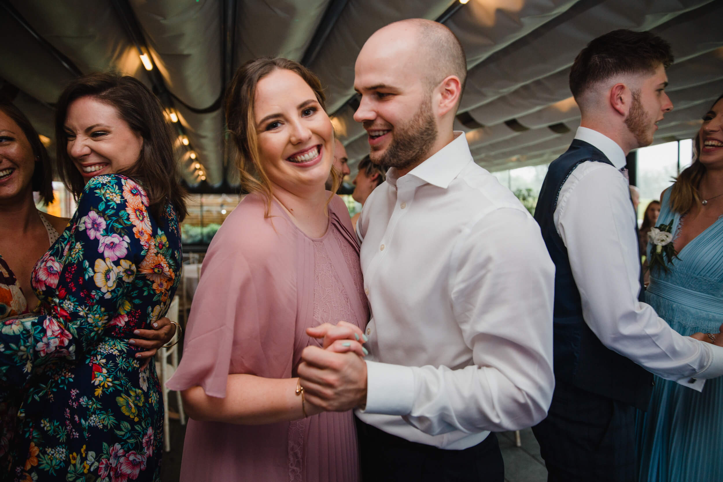 bridesmaid and usher dancing together at The Colony HQ