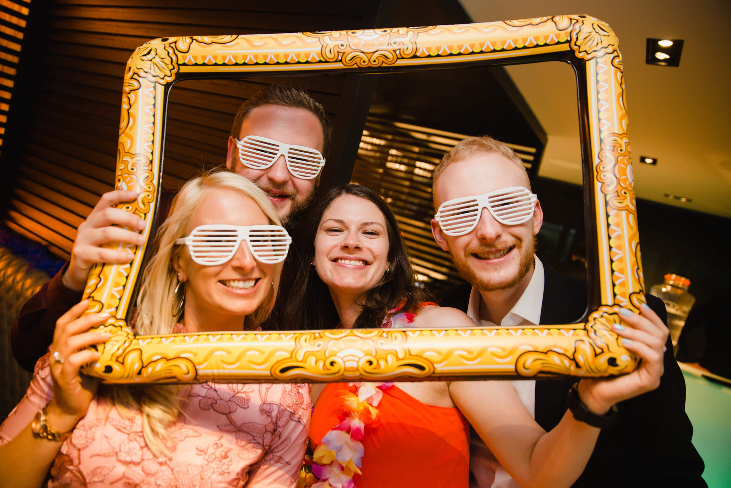 wedding guests settle for pose in frame for photograph