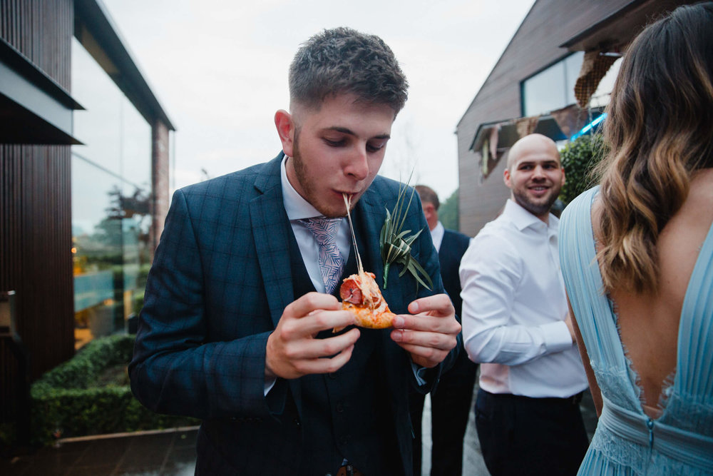 groomsman enjoying cheese pizza