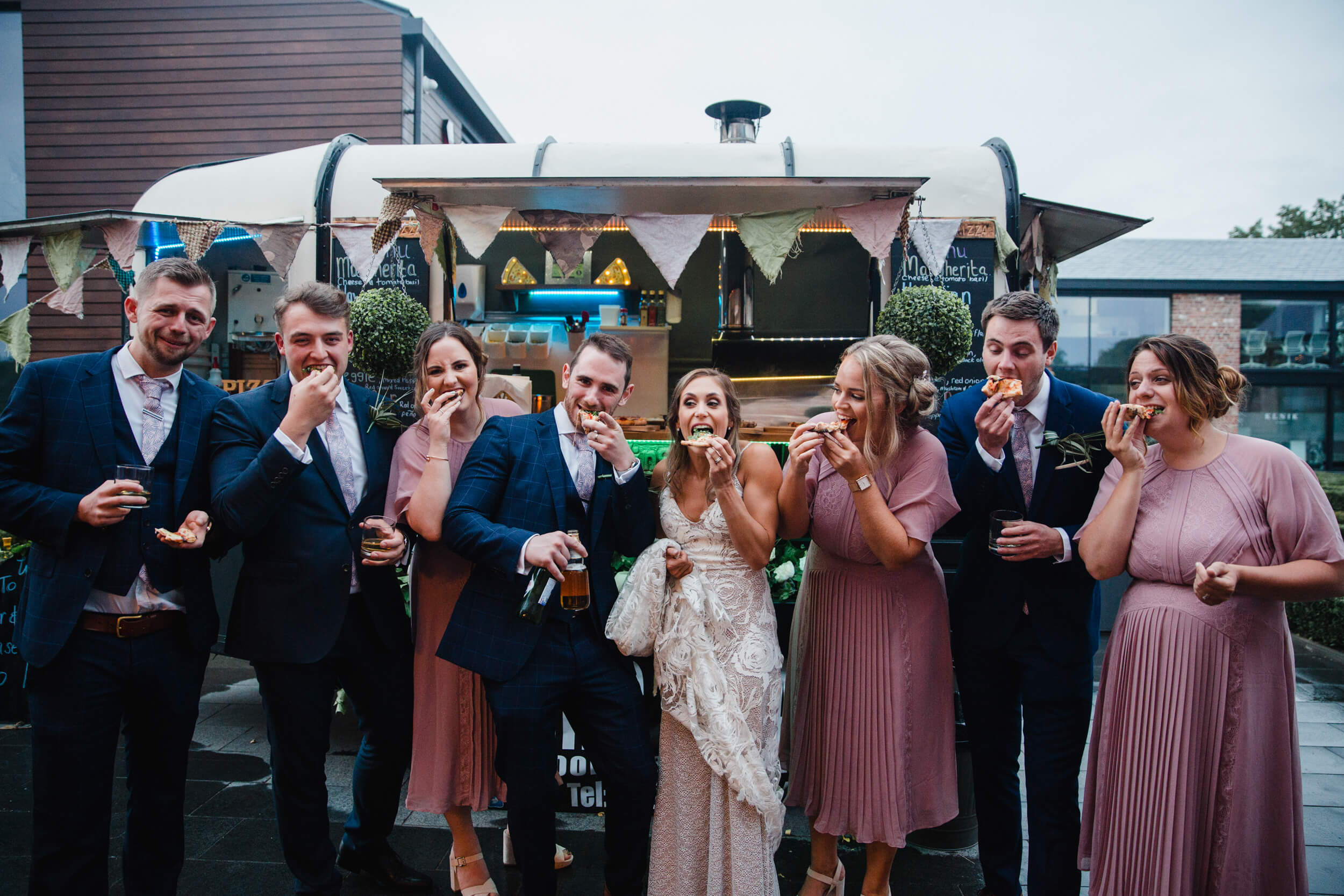 bridal party pose in front of pizza van