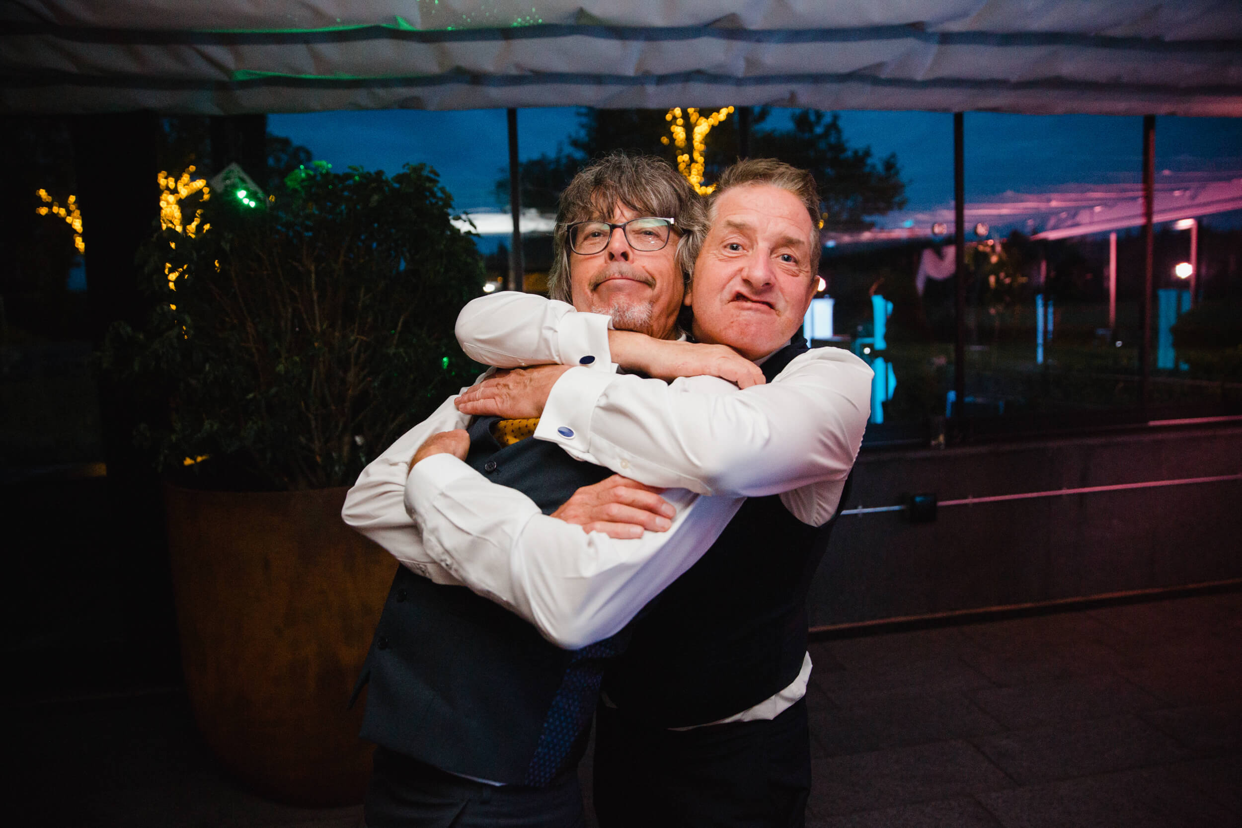 father of groom posing for camera on dance floor