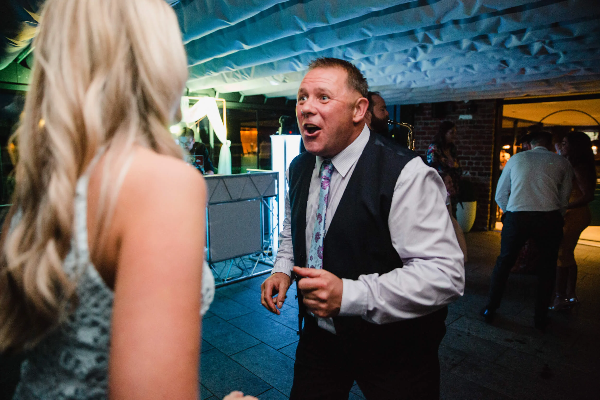 wedding guests dancing lit up using flash bounce