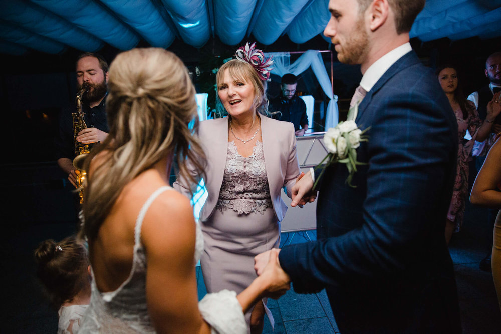 newlyweds dancing with family at the end of the night