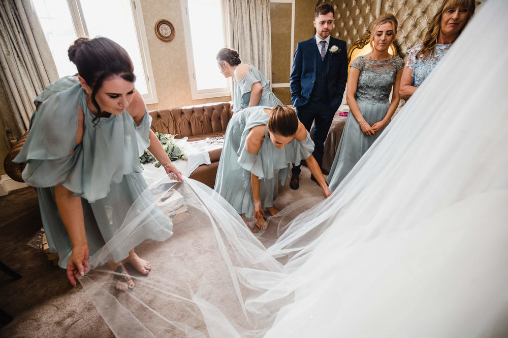 bridesmaids arranging brides wedding veil