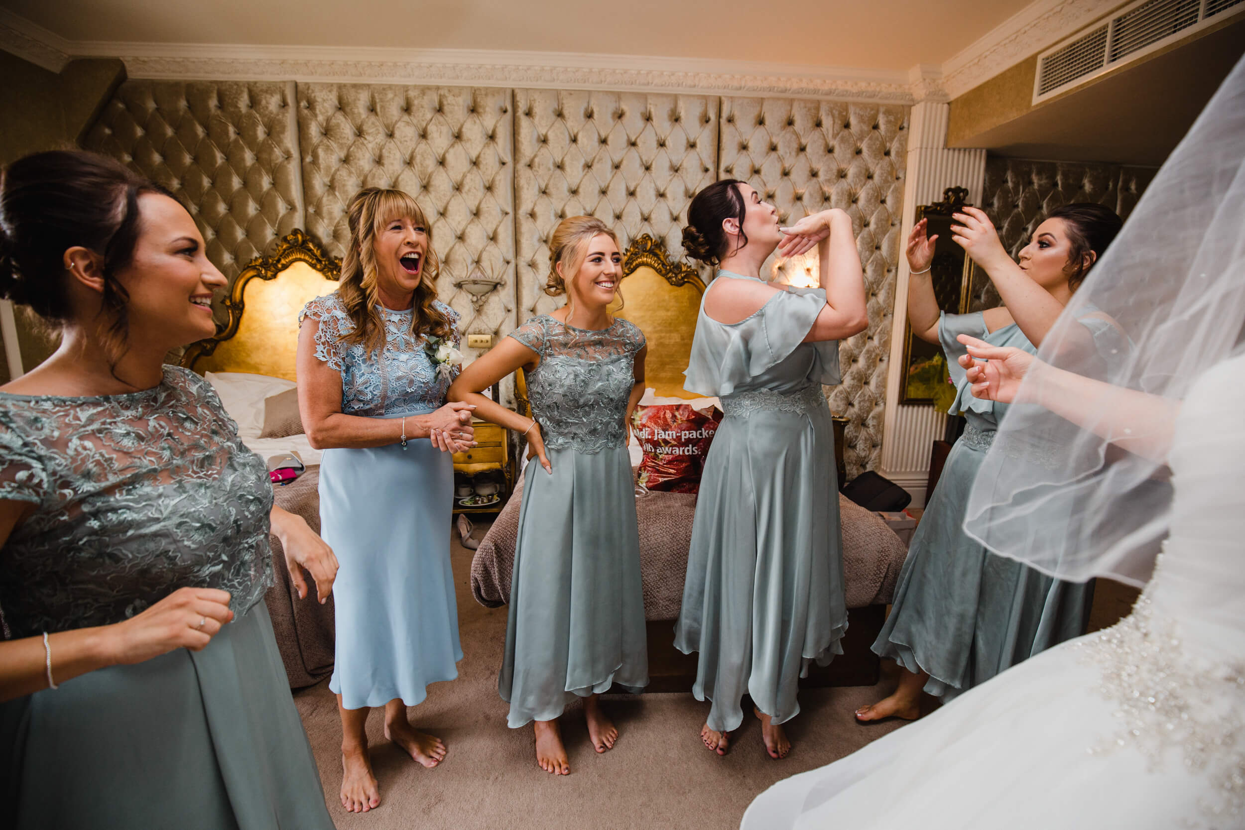 emotional reactions of bridesmaids to bride in dress