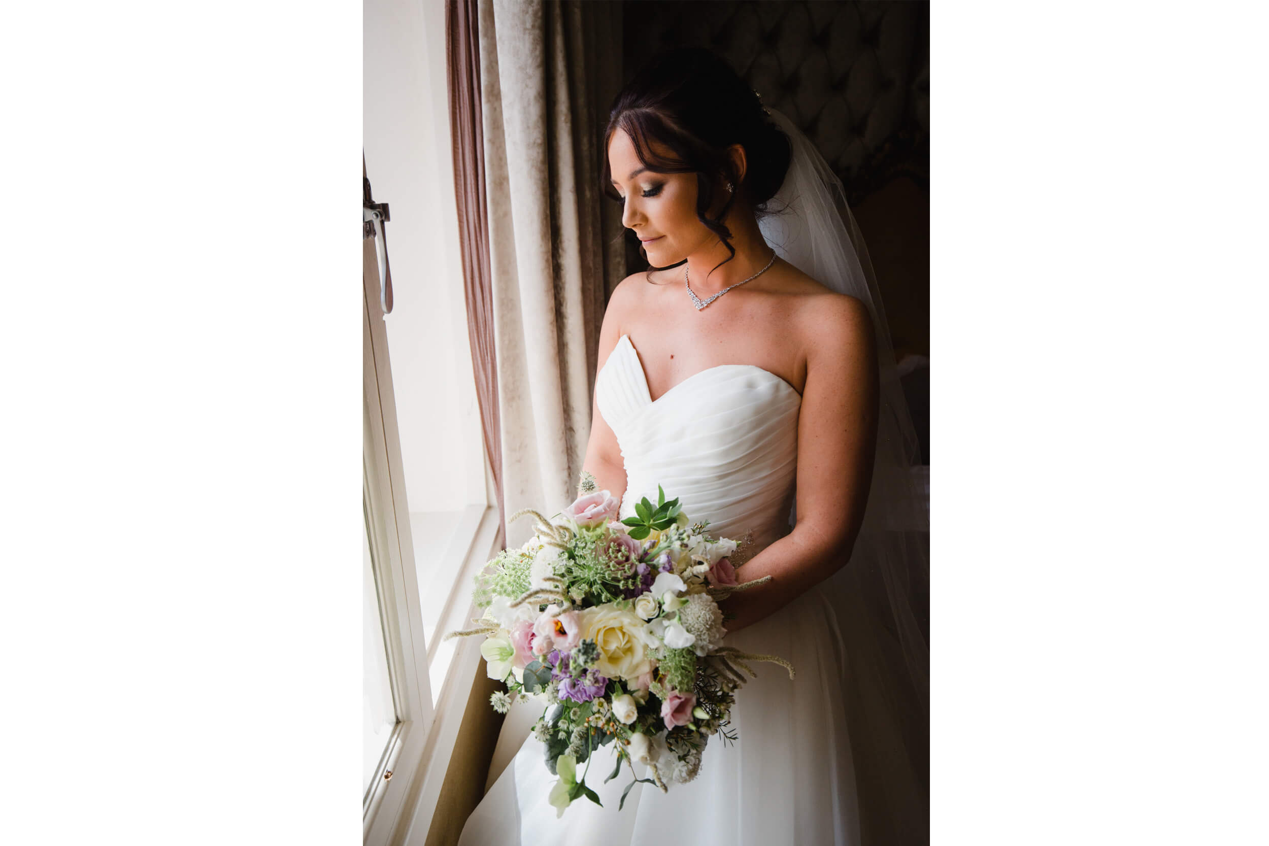 portrait photograph of bride holding bouquet by the window for her 30 james street wedding