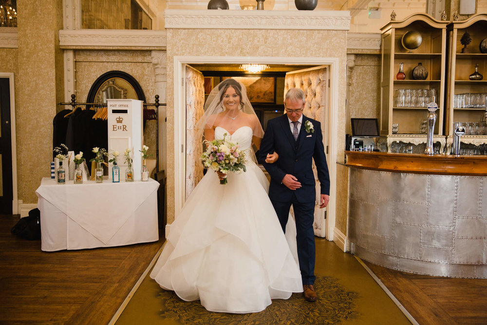 bride entering hotel foyer for wedding ceremony