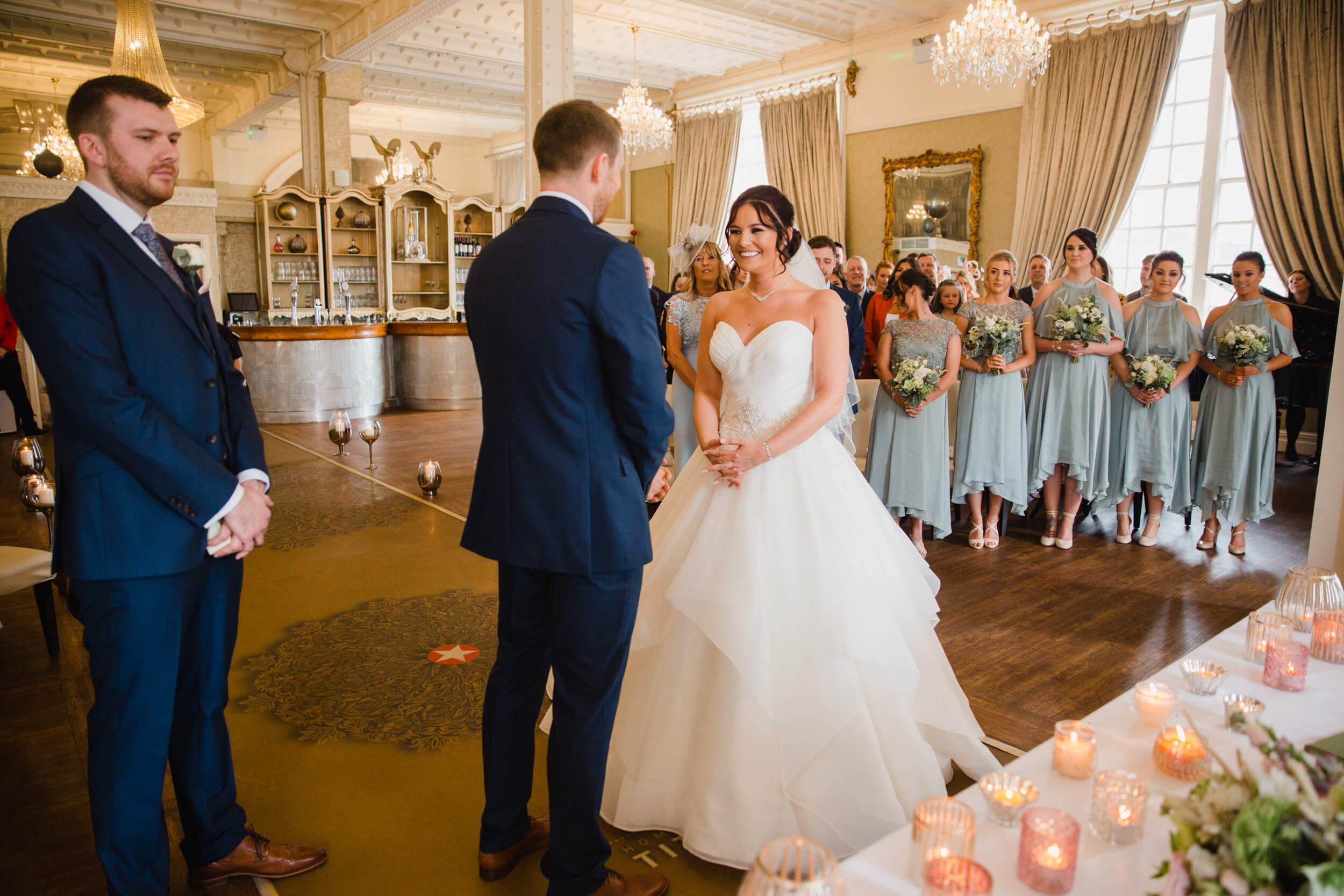 wide angle lens photograph of wedded couple surrounded by friends and family at 30 James Street Hotel