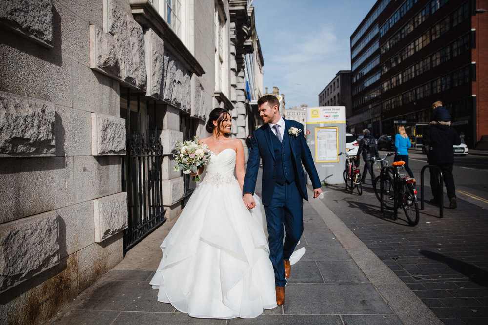 newly wedded couple streetwalking for natural portraits 