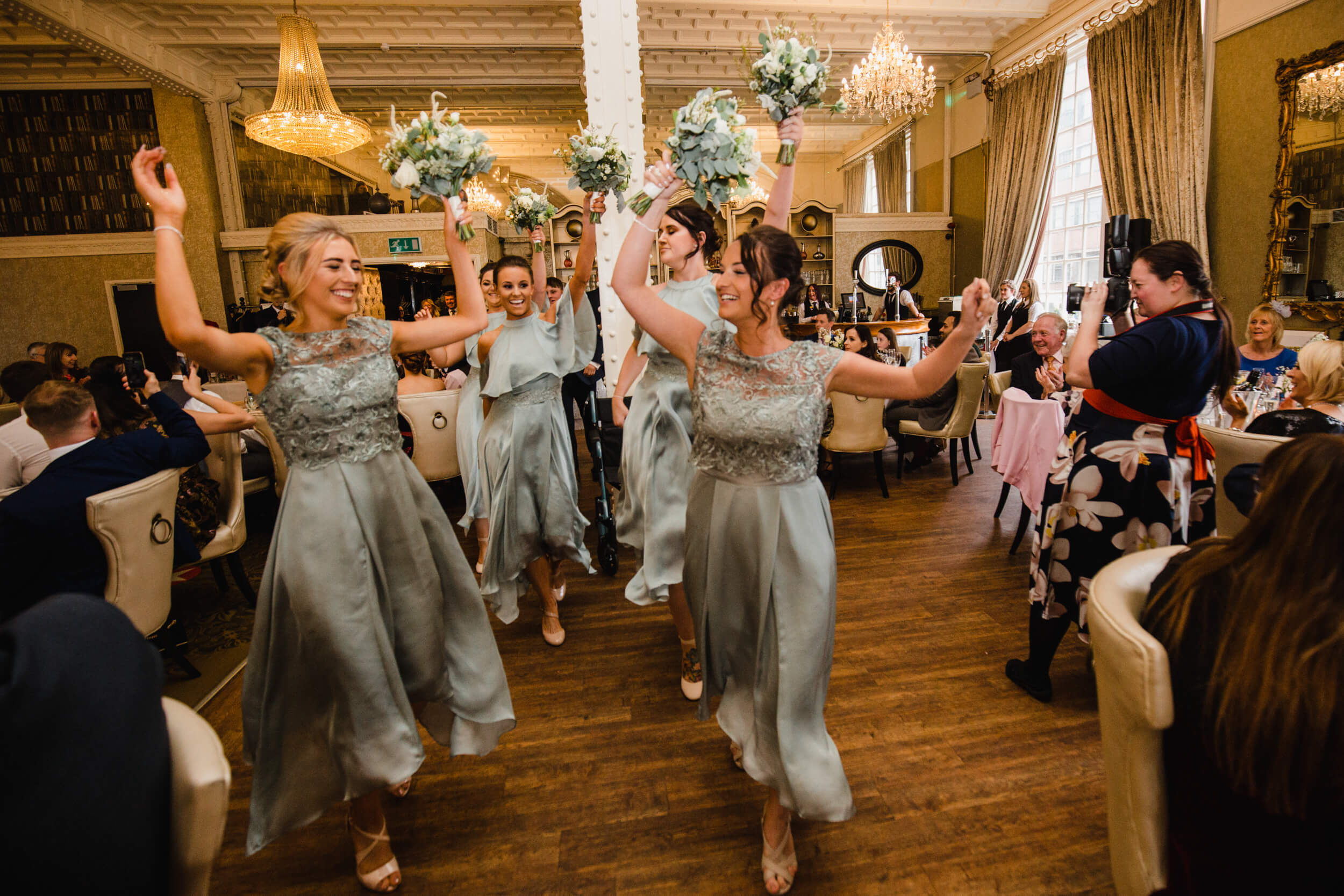 bridesmaids dancing while entering wedding breakfast room
