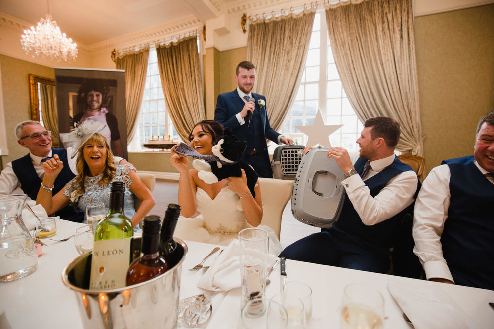 best man presents wedding couple with kitten toys