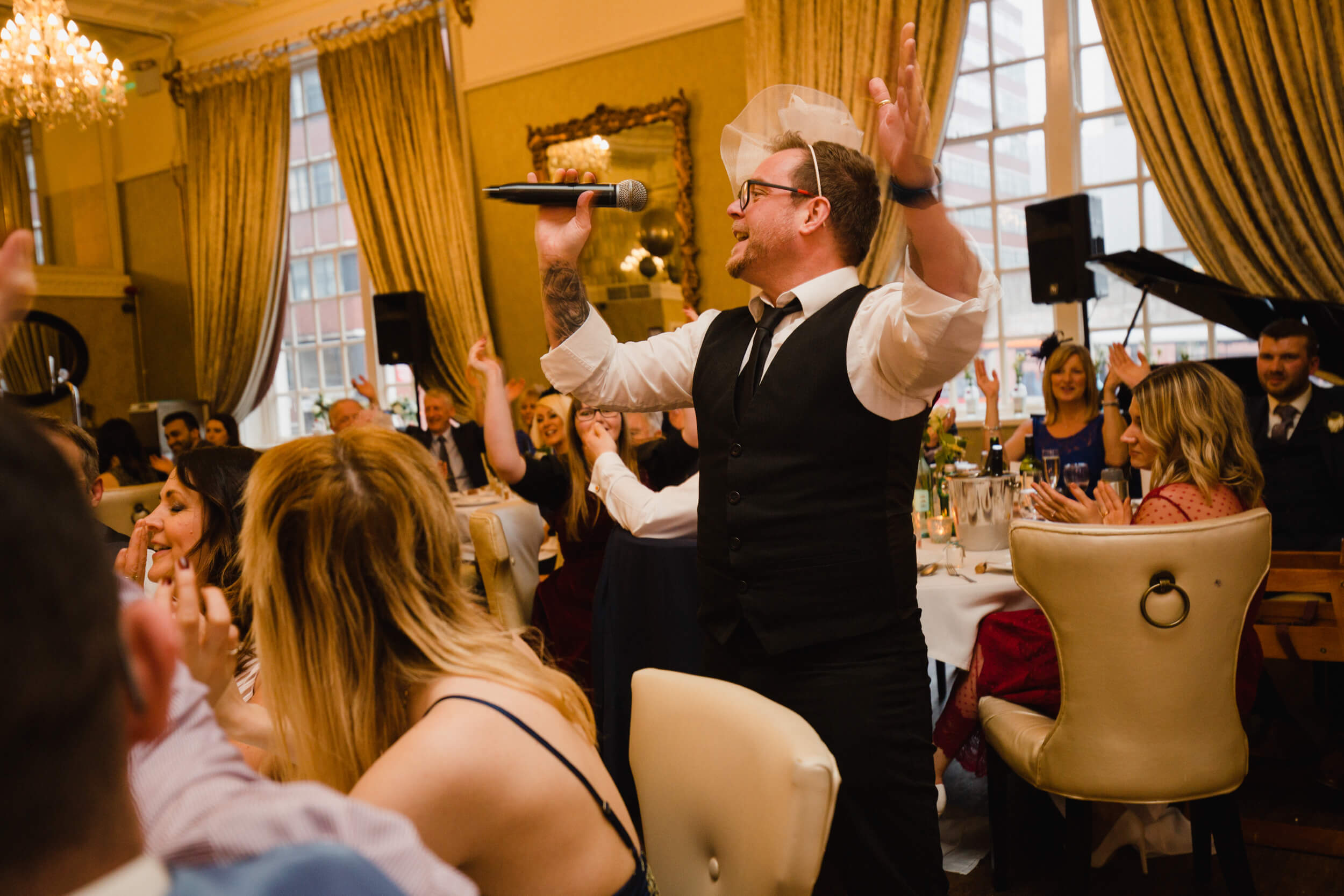 singing waiter wearing hat entertaining wedding party at 30 James Street Hotel