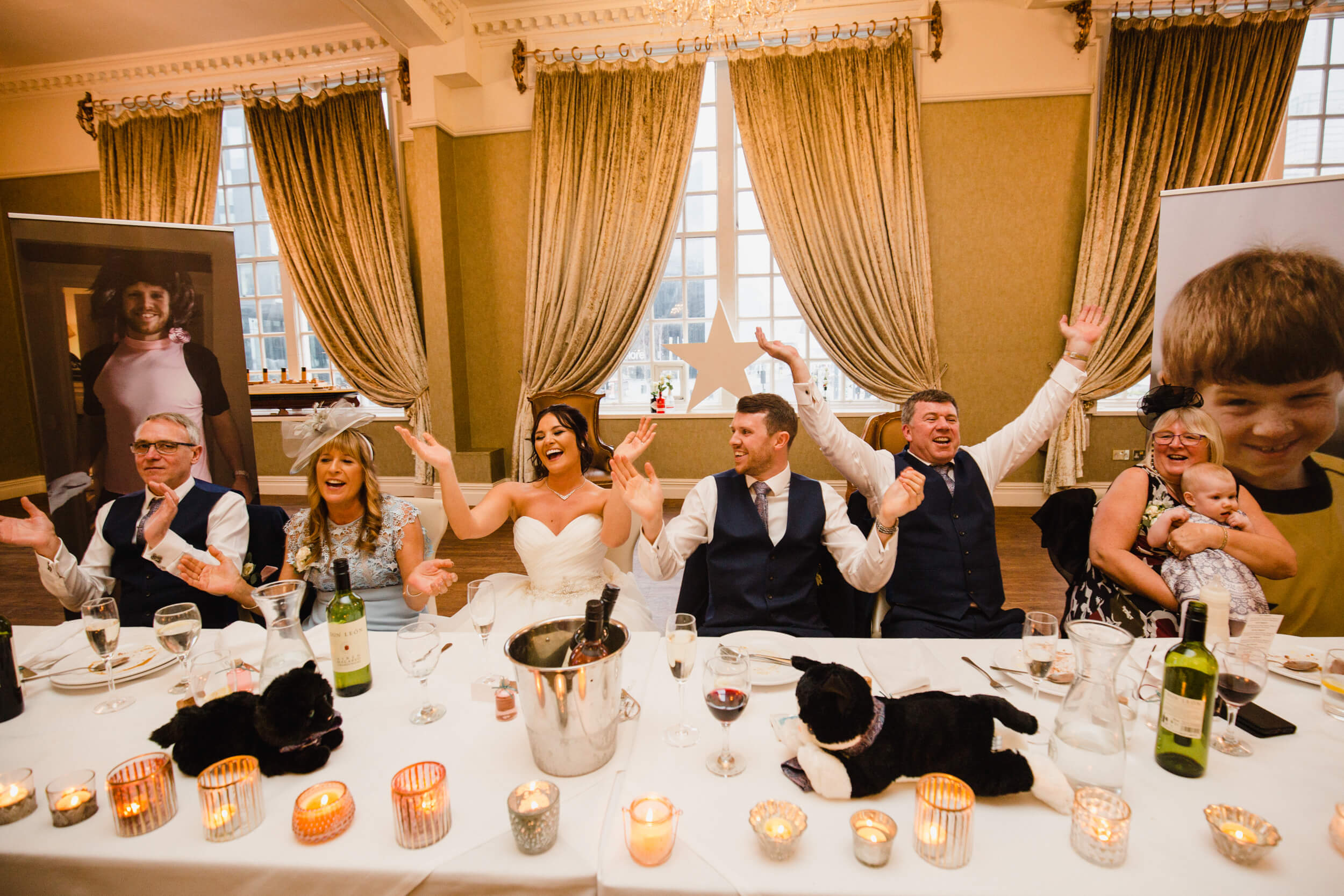 wide angle lens photograph of top table dancing to singing waiters music