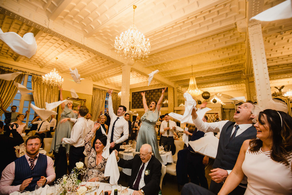 bridal party and groomsmen all throwing napkins in the air at 30 James Street Hotel