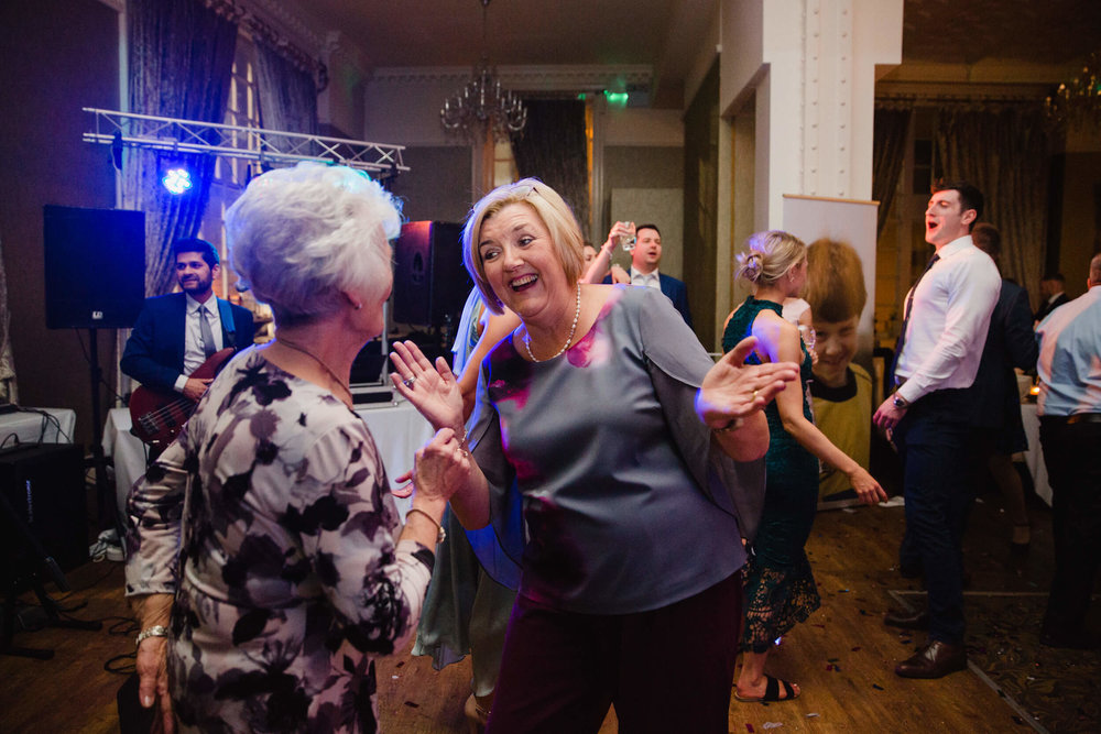 aunties dancing to band music at the end of wedding day