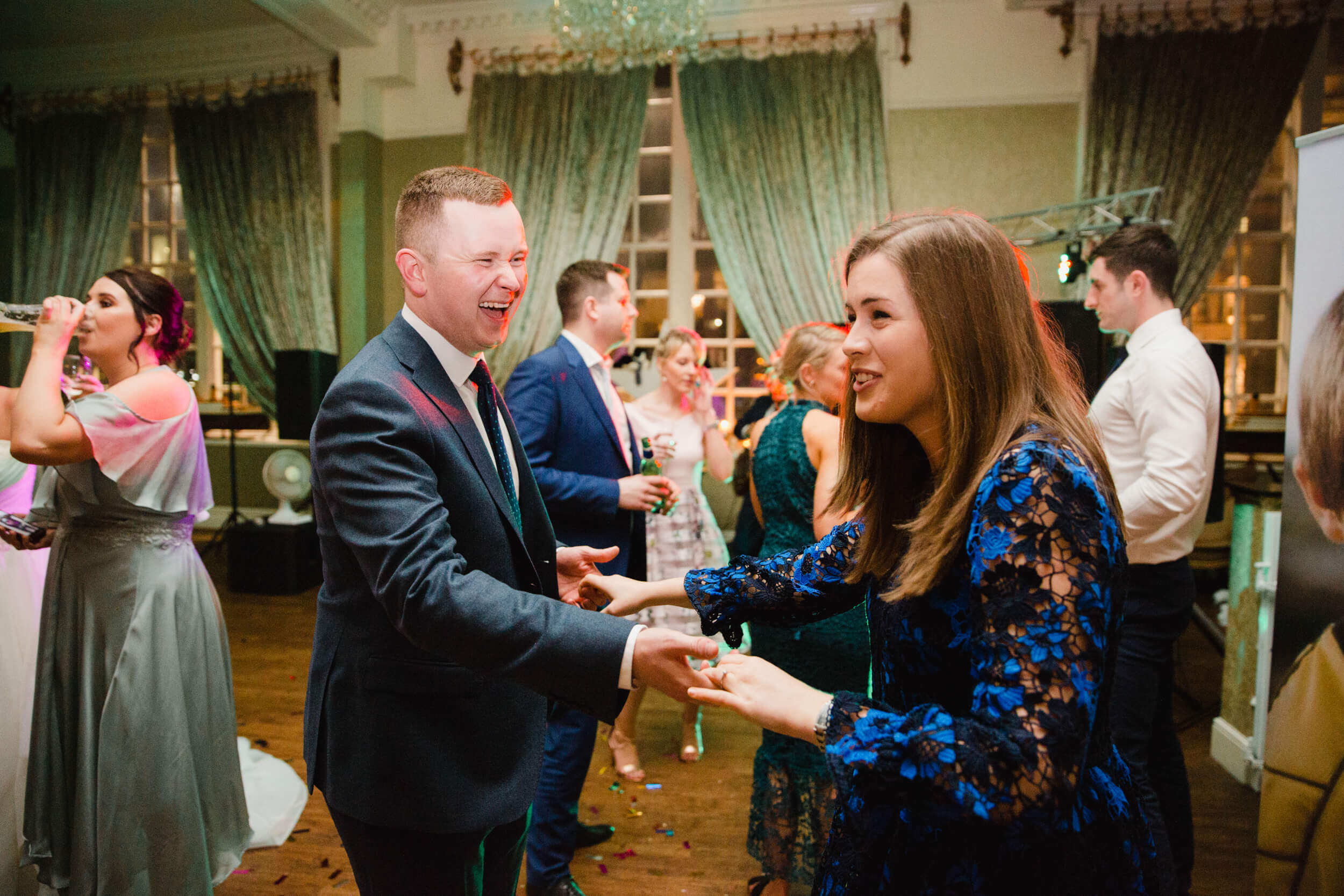 groomsman and partner laughing and dancing on dance floor at 30 James Street