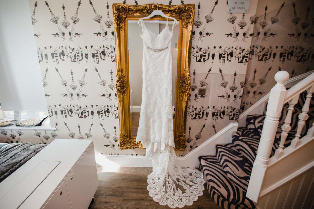 wedding dress hung up on mirror at oddfellows on the park