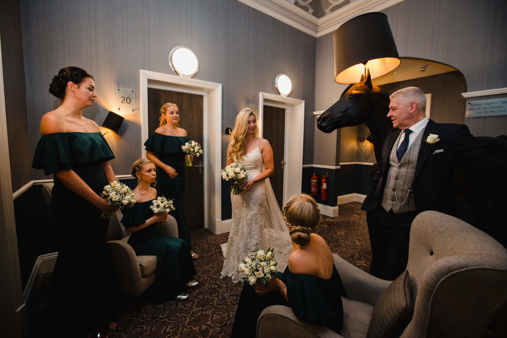 bridal party holding bouquets in hallway at oddfellows on the park 