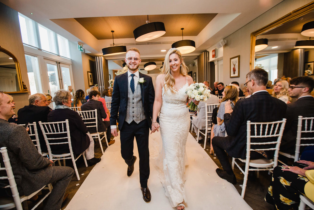 newlyweds happily married walking towards camera at oddfellows on the park