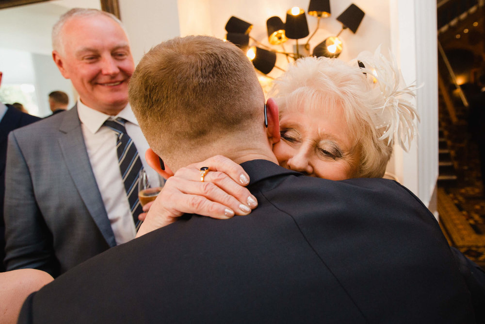 grandmother hugs and shares intimate moment with groom