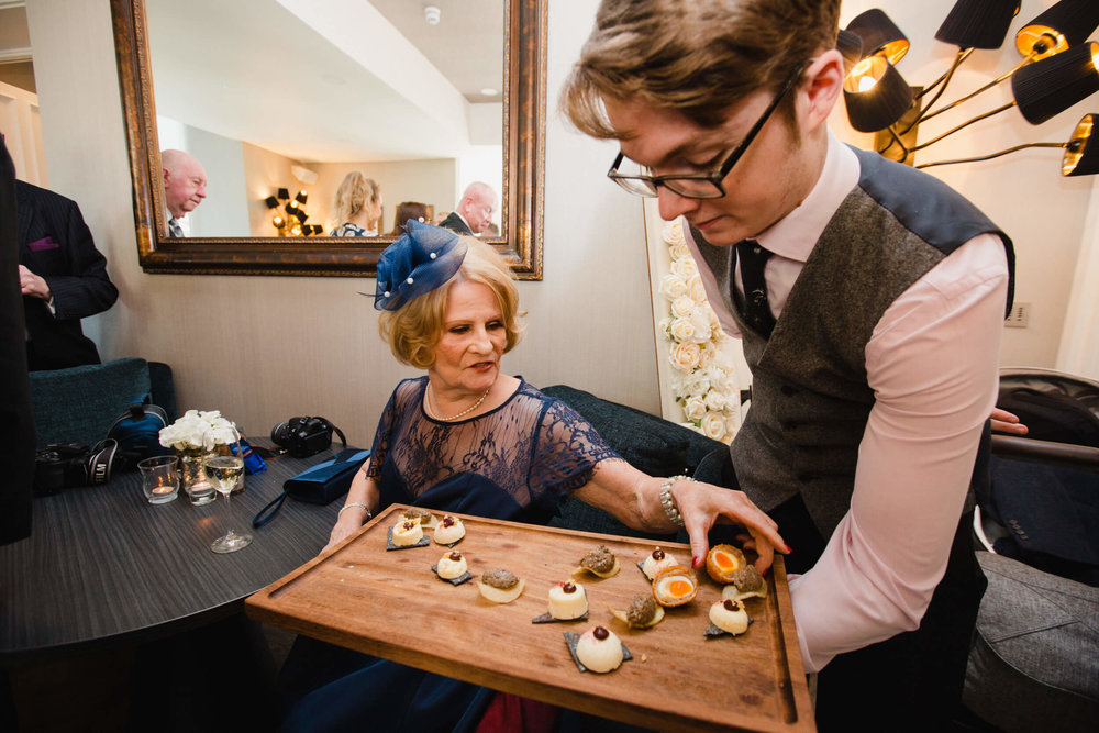 wedding guest reaches out for canapé