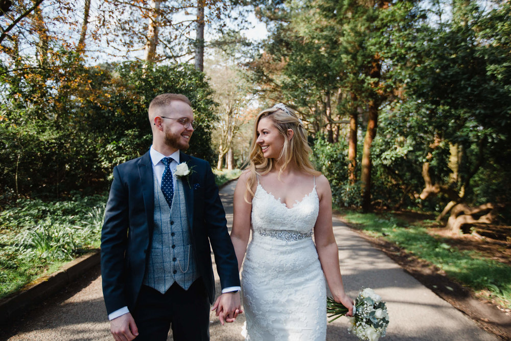 newly married couple walking towards carpark