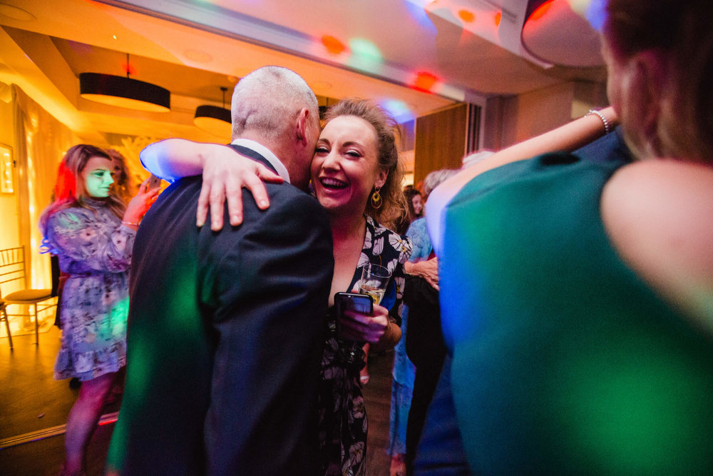 wedding guests dancing and laughing