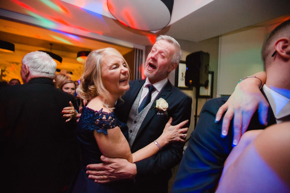 mother and father of groom dancing after first dance