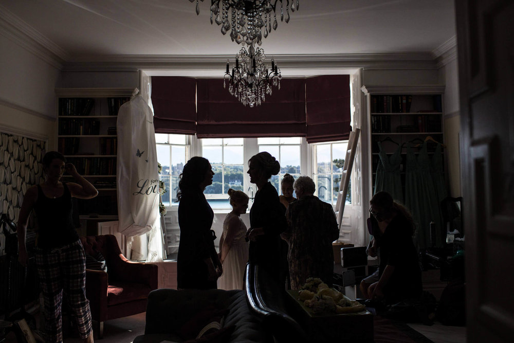 low light exposure silhouette photograph of bridal party during their preparation