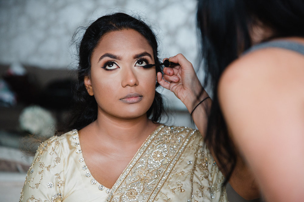 close up macro lens photograph of bride having make up applied