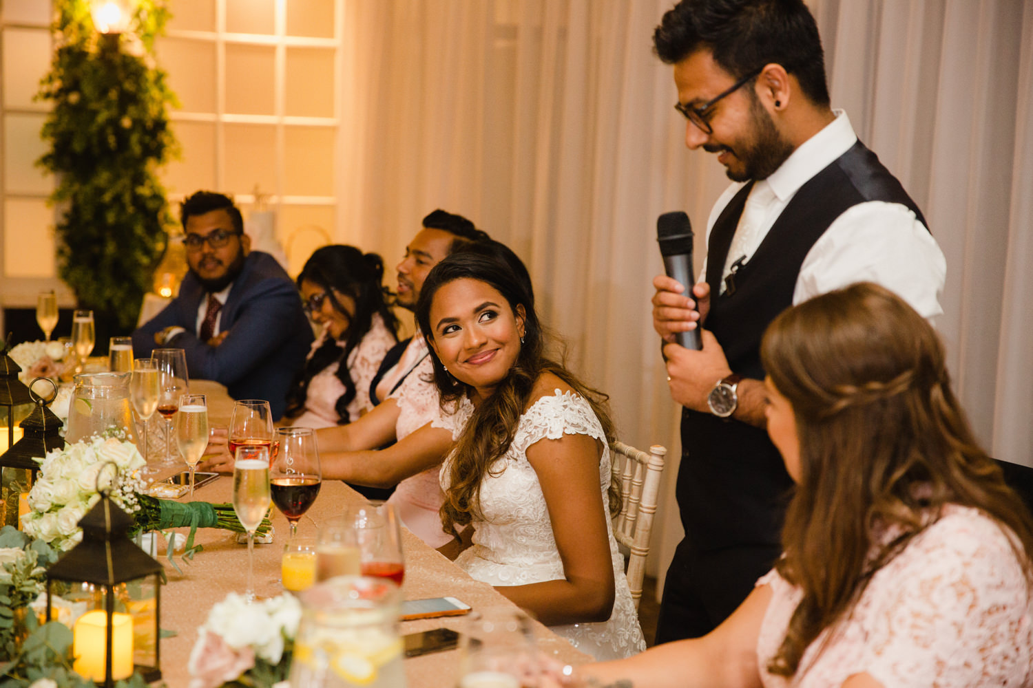 bride smiling at groom delivering his speech at delamere manor