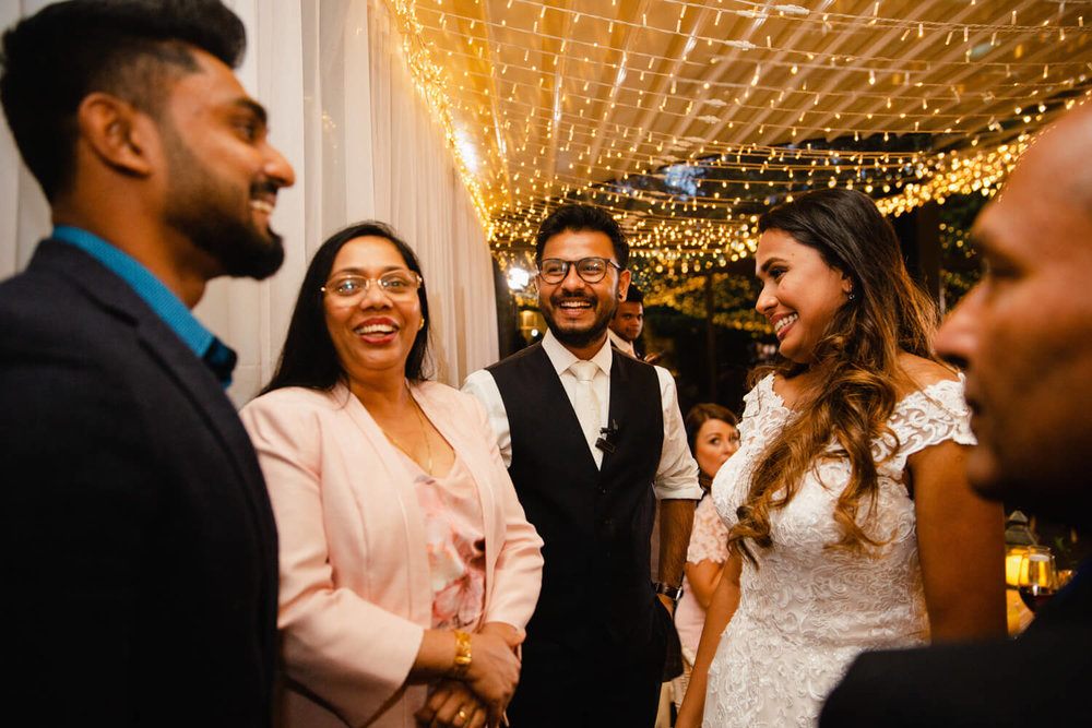 newly married couple laughing with friends and family at delamere manor