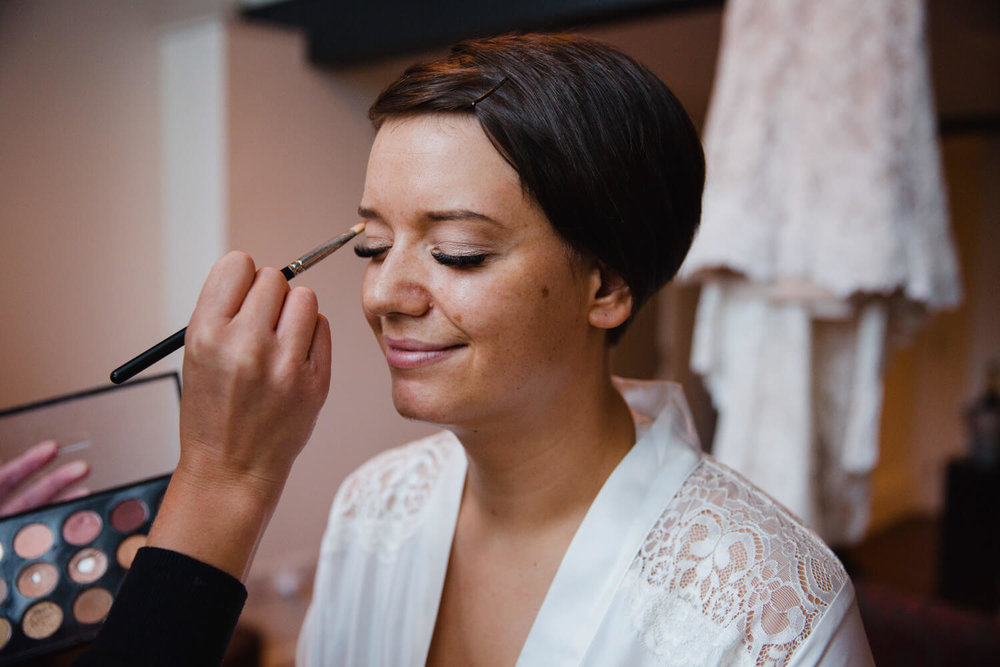 Copy of close up macro lens photograph of bride having make up applied in window at great john street hotel