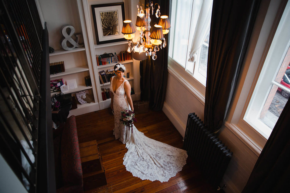 Copy of wide angle lens portrait of bride in wedding dress posing with bouquet of flowers at great john street hotel
