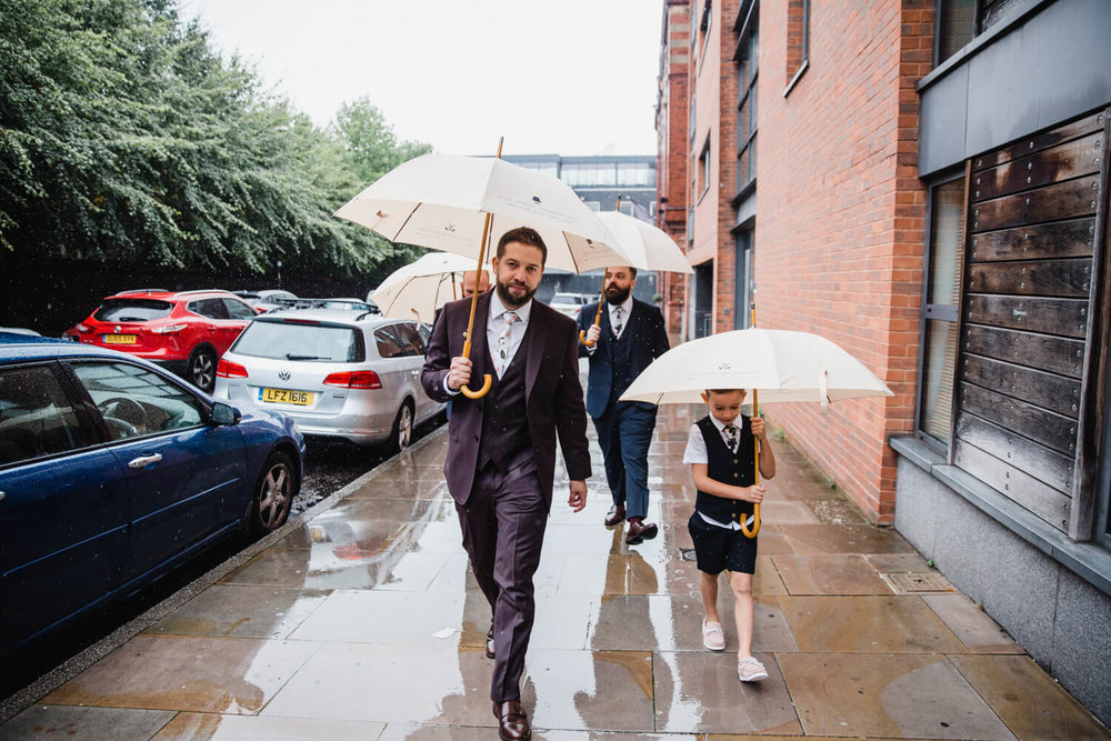 Copy of groom making his way to the ceremony with page boy